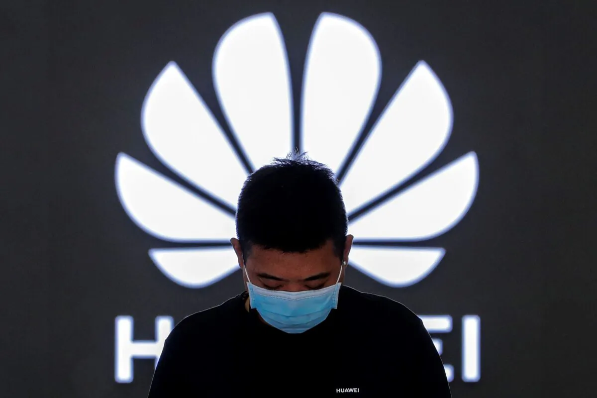 An employee stands inside a Huawei flagship store in Beijing, on April 12, 2021. (Andy Wong/AP Photo)