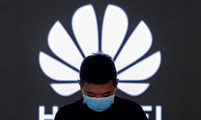 An employee stands inside a Huawei flagship store in Beijing, on April 12, 2021. (Andy Wong/AP Photo)