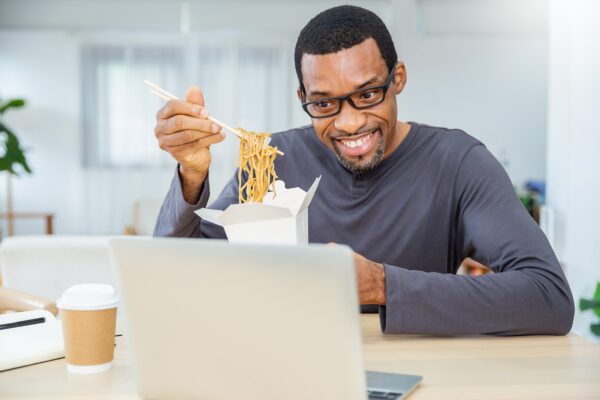 Portrait,Of,Afican,Business,Man,Enjoying,Chinese,Food,In,Office