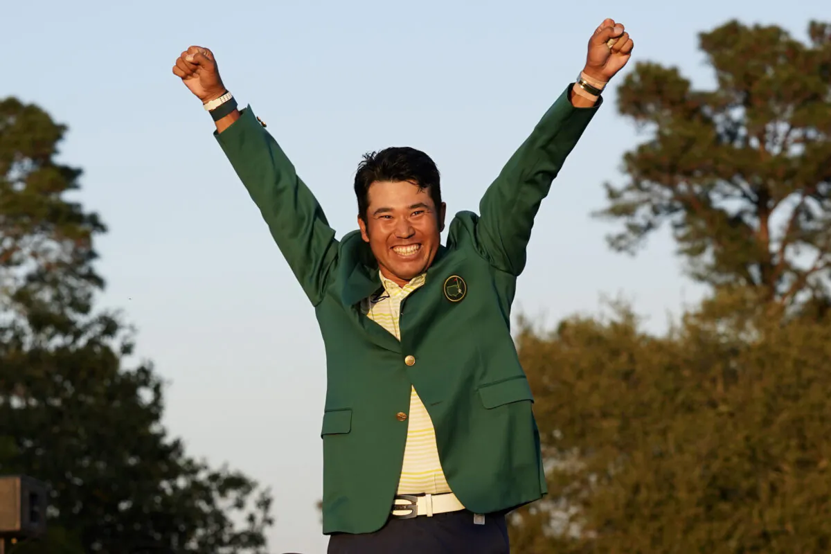 Hideki Matsuyama, of Japan, celebrates after putting on the champion's green jacket after winning the Masters golf tournament in Augusta, Ga., on April 11, 2021. (Gregory Bull/AP Photo)