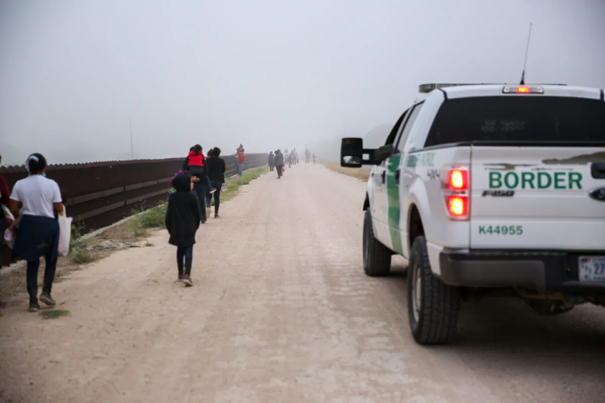 A group of illegal immigrants with Border Patrol after crossing the U.S.-Mexico border in La Joya, Texas, on April 10, 2021. (Charlotte Cuthbertson/The Epoch Times)
