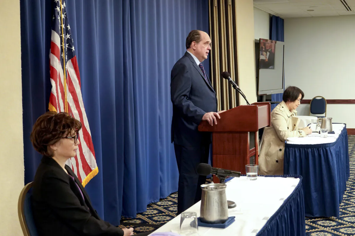 Epoch Times publisher Stephen Gregory speaks as Guo Jun (R), director of the Hong Kong edition of The Epoch Times, looks on, during a press conference about the attack on the printing press of the Hong Kong edition of The Epoch Times, at the National Press Club in Washington on April 13, 2021. (Jenny Jing/Epoch Times)