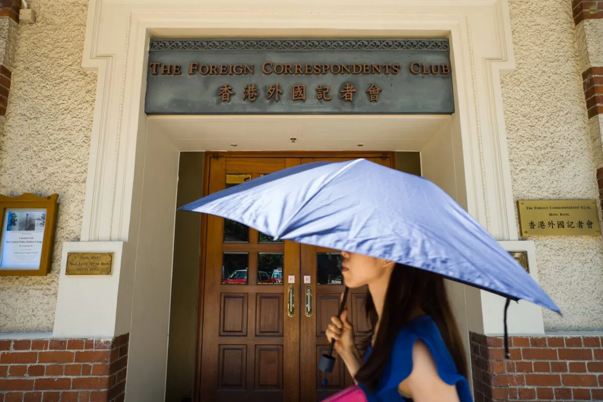 A pedestrian walks past the entrance of the Foreign Correspondents' Club (FCCHK) in Hong Kong on Aug. 8, 2018. (Anthony Wallace/AFP via Getty Images)
