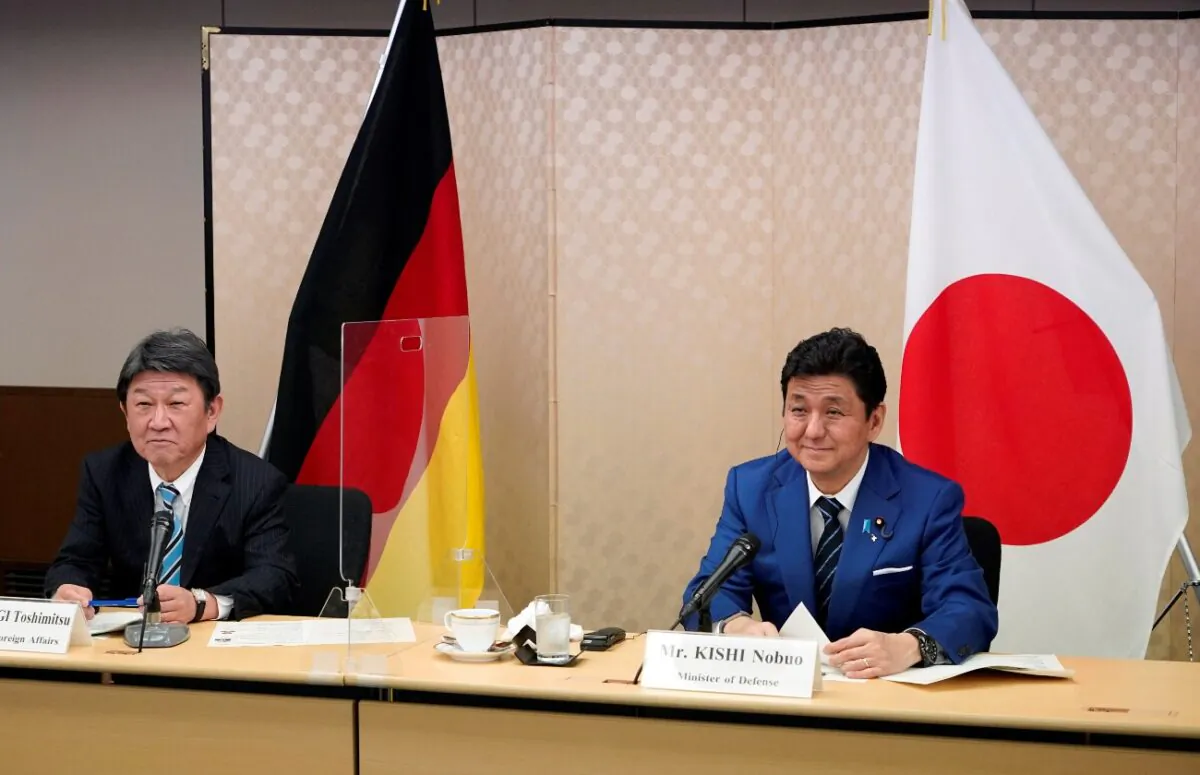 Japan's Foreign Minister Toshimitsu Motegi (L) and Defence Minister Nobuo Kishi (R) attend a video conference with German Foreign Minister Heiko Maas (not pictured) and Defence Minister Annegret Kramp-Karrenbauer (not pictured) at the Foreign Ministry in Tokyo, Japan, on April 13, 2021. (Franck Robichon/Pool via Reuters)