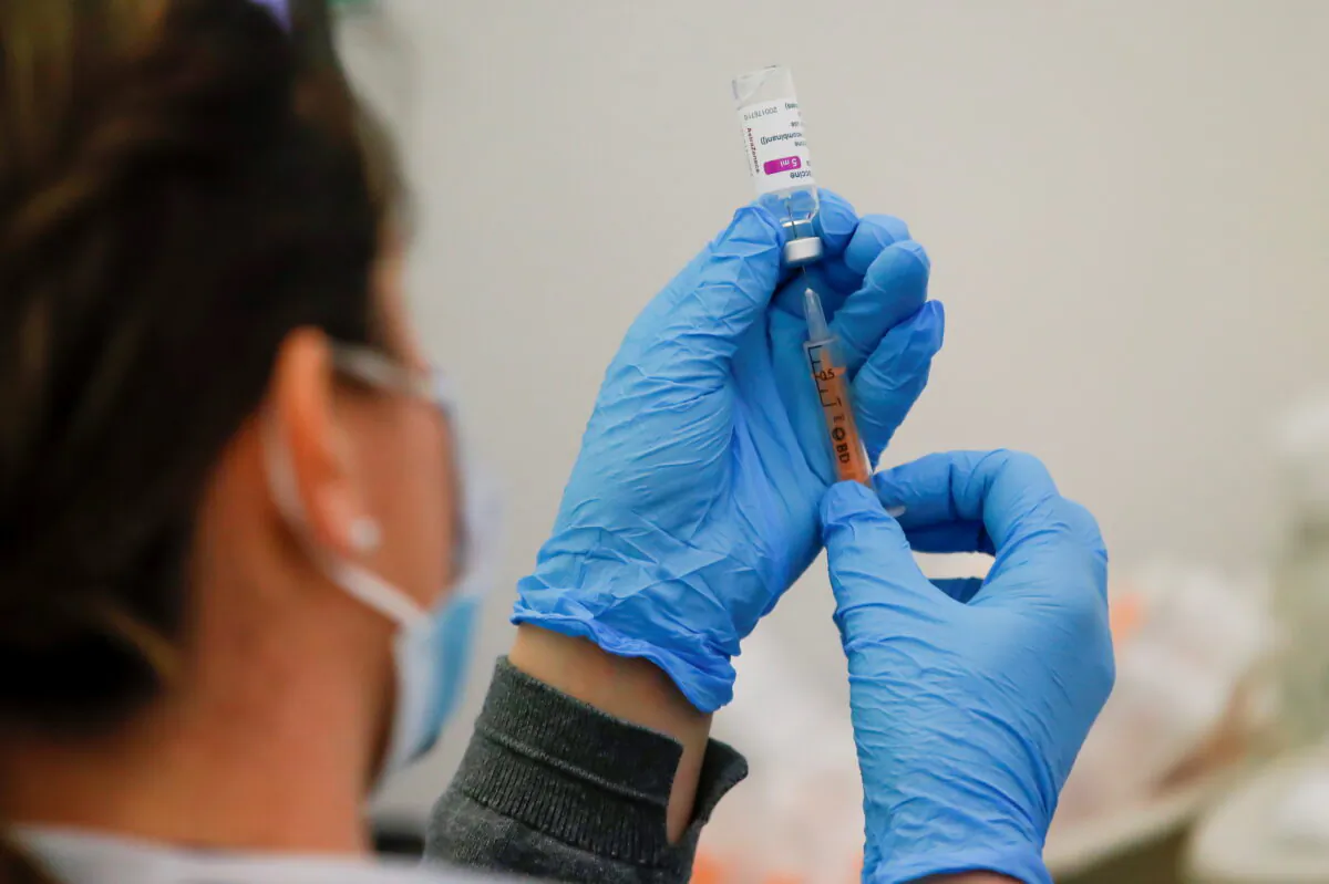 A dose of the AstraZeneca COVID-19 vaccine is prepared in a vaccination centre at Newmarket Racecourse, amid the coronavirus disease outbreak in Newmarket, Britain, on March 26, 2021. (Andrew Couldridge/Reuters)