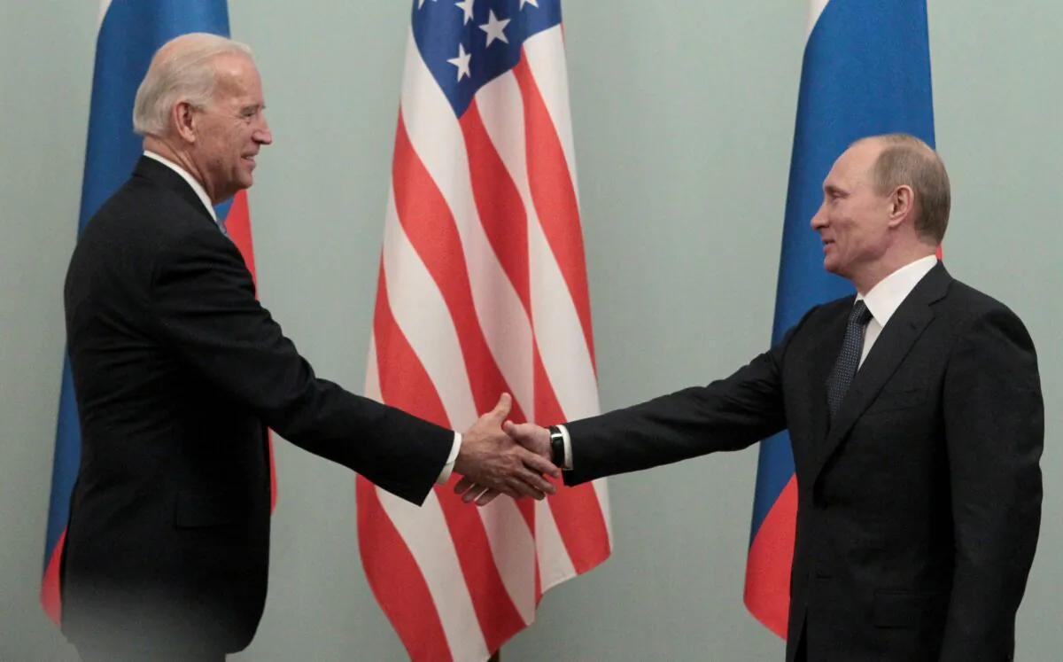 File photo showing then Russian Prime Minister Vladimir Putin shaking hands with then U.S. Vice President Joe Biden, in Moscow on March 10, 2011. (Alexander Natruskin/Reuters)