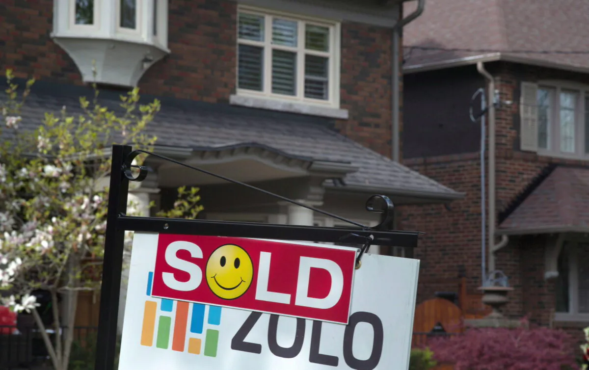 A sold sign is displayed in front of west-end Toronto homes in this file photo. (The Canadian Press/Graeme Roy)
