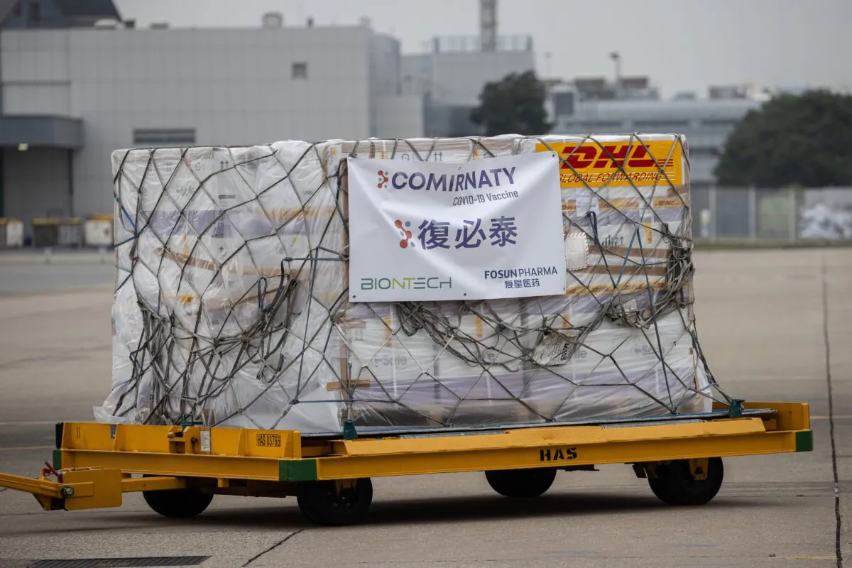 A trolley carrying cartons of Pfizer-BioNTech COVID-19 vaccine is transported to a warehouse after being unloaded from a Cathay Pacific cargo plane at Hong Kong International Airport on Feb. 27, 2021. (Jerome Favre/POOL/AFP via Getty Images)