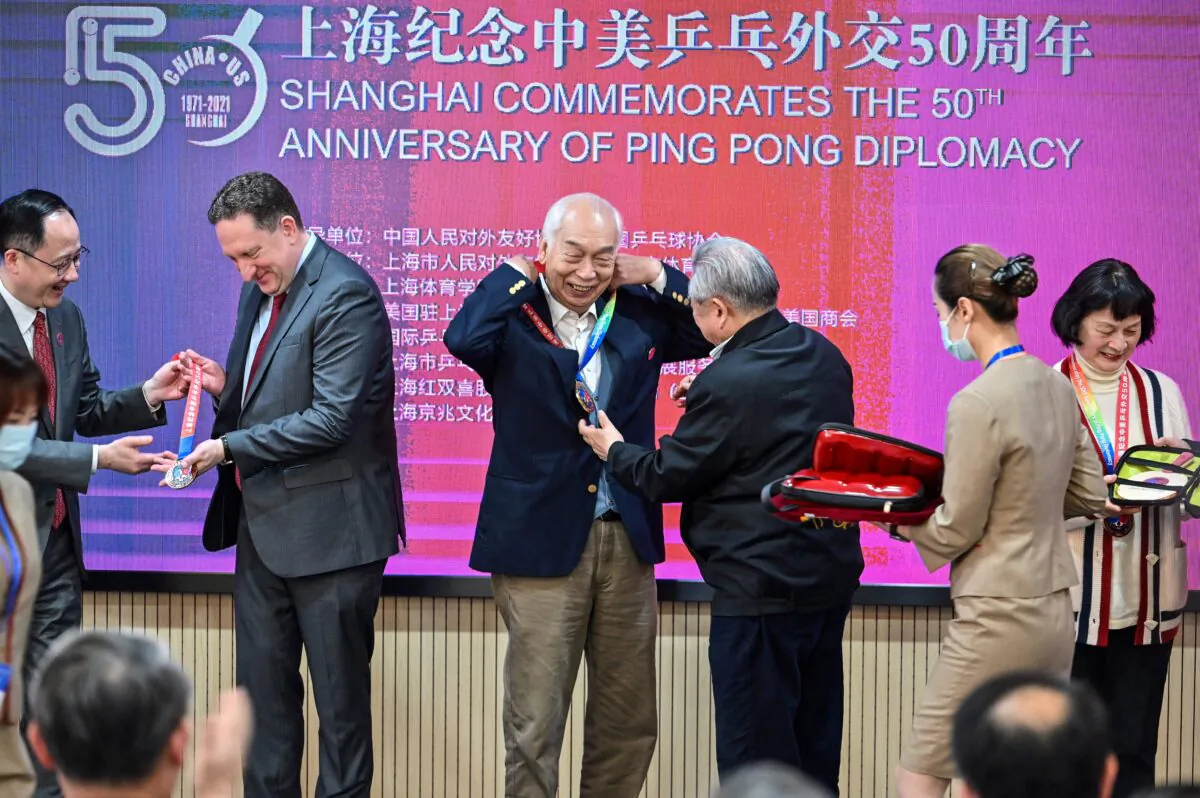 U.S. Consul General in Shanghai James Heller (2nd L) with former Chinese table tennis player Zhang Xielin (2nd R) during a ceremony to mark the 50th anniversary of Ping-Pong Diplomacy at the International Table Tennis Federation museum in Shanghai on April 10, 2021. (Hector Retamal/AFP via Getty Images)