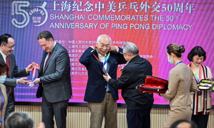 U.S. Consul General in Shanghai James Heller (2nd L) with former Chinese table tennis player Zhang Xielin (2nd R) during a ceremony to mark the 50th anniversary of Ping-Pong Diplomacy at the International Table Tennis Federation museum in Shanghai on April 10, 2021. (Hector Retamal/AFP via Getty Images)