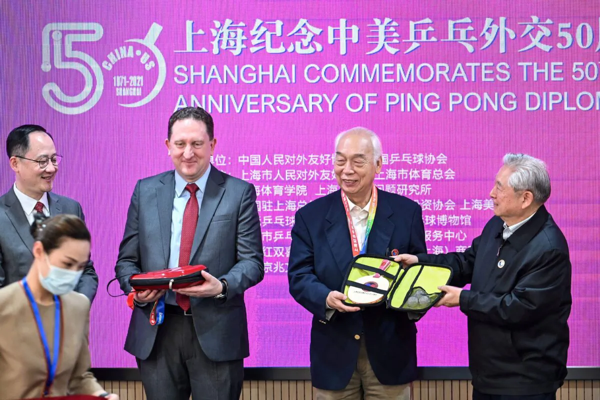 U.S. Consul General in Shanghai James Heller (2nd L) with former Chinese table tennis player Zhang Xielin (2nd R) during a ceremony to mark the 50th anniversary of Ping-Pong Diplomacy at the International Table Tennis Federation museum in Shanghai on April 10, 2021. (Hector Retamal/AFP via Getty Images)