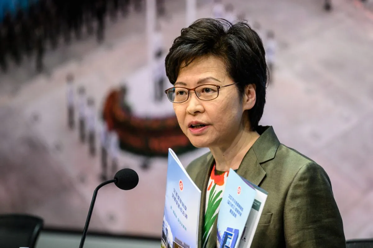 Hong Kong Chief Executive Carrie Lam holds a pamphlet for the "Improving Electoral System (Consolidated Amendments) Bill 2021" as she speaks during a press conference at the government headquarters in Hong Kong on April 13, 2021. (Anthony Wallace/AFP via Getty Images)