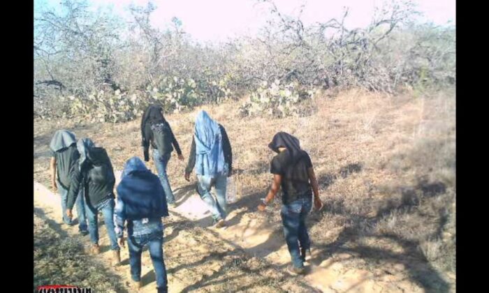 A game camera captures illegal immigrants walking through private ranch land in Jim Hogg County, Texas, on March 25, 2021. (Courtesy of Susan Kibbe)