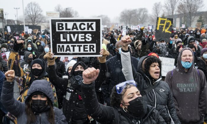Demonstrators march to Brooklyn Center Police Department to protest the fatal shooting of Daunte Wright during a traffic stop in Brooklyn Center, Minn. on April 13, 2021. (John Minchillo/AP Photo)