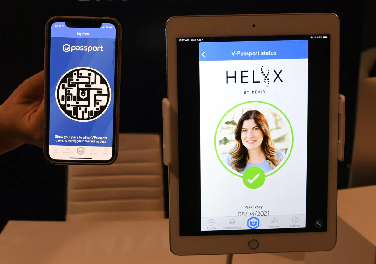 REVIV USA West Coast Operations Manager Kari Armamento uses a cell phone and an iPad to demonstrate the HELIIX Health Passport at REVIV at The Cosmopolitan of Las Vegas in Las Vegas, Nev., on April 7, 2021. (Ethan Miller/Getty Images)