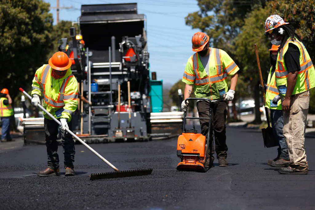 Workers with the San Francisco Department of Public Works repave a section of 24th Avenue in San Francisco, Calif., on April 8, 2021. (Justin Sullivan/Getty Images)