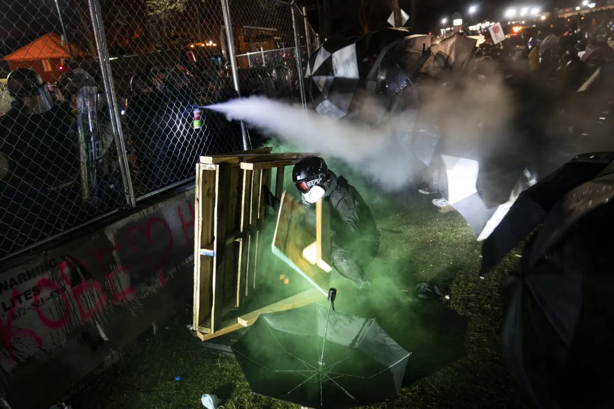 A demonstrator is seen during a standoff with police during a protest decrying the shooting death of Daunte Wright, outside the Brooklyn Center Police Department in Brooklyn Center, Minn., on April 14, 2021. (John Minchillo/AP Photo)