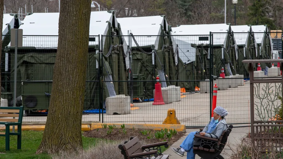 A worker takes a break outside the mobile field hospital at Sunnybrook Hospital in Toronto on April 9, 2021. (Frank Gunn/The Canadian Press)