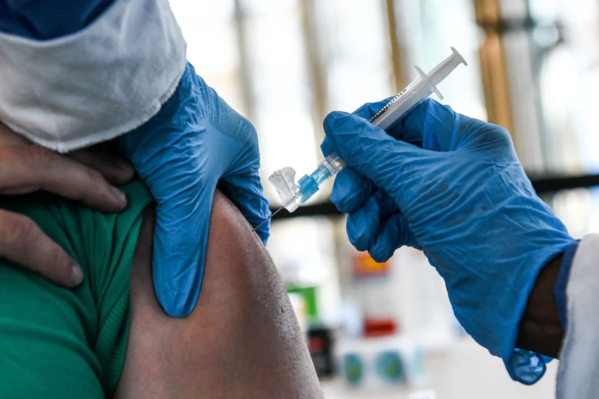 A healthcare worker administers a COVID-19 vaccine to a person in Miami Gardens, Fla., on April 14, 2021. (Chandan Khanna/AFP via Getty Images)