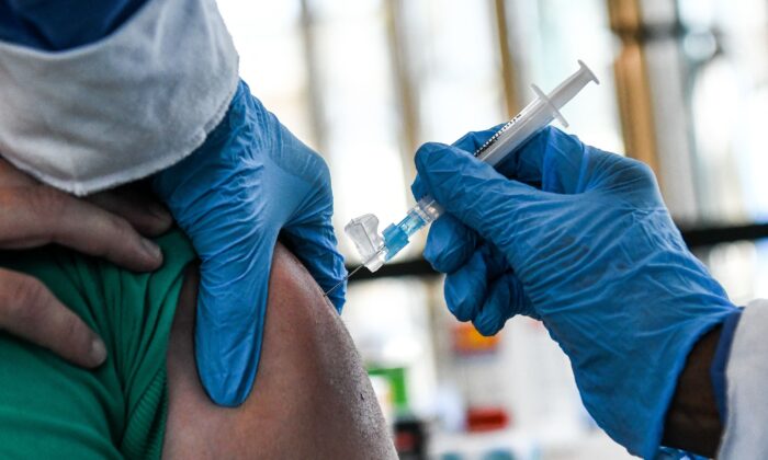 A healthcare worker administers a COVID-19 vaccine to a person in Miami Gardens, Fla., on April 14, 2021. (Chandan Khanna/AFP via Getty Images)