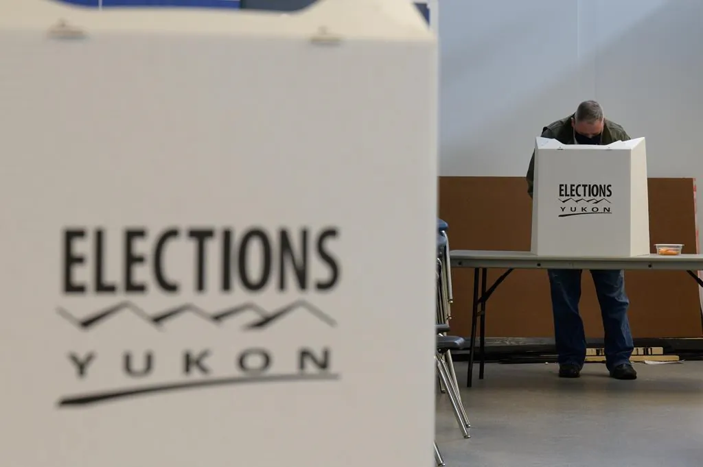 A voter is shown at a Whitehorse polling station during the Yukon election on April 12, 2021. An official count has confirmed a tie in the Yukon election, pushing the process to the next step of a judicial recount. (Mark Kelly/The Canadian Press)