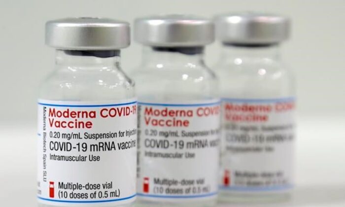 Three vials of the Moderna COVID-19 vaccine are pictured in a new coronavirus, COVID-19, vaccination center at the Velodrome-Stadium in Berlin, Germany, on Feb. 17, 2021. (The Canadian Press/AP/Michael Sohn, pool)