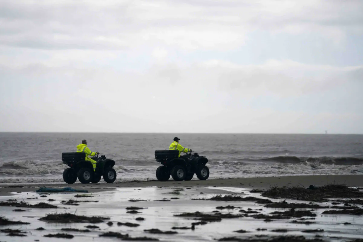 Lafourche Parish deputies patrol along the shoreline of the Gulf of Mexico, not far from where a lift boat capsized during a storm on Tuesday, killing one with 12 others still missing, on Elmer's Island, La., on Thursday, April 15, 2021. (Gerald Herbert/AP Photo)