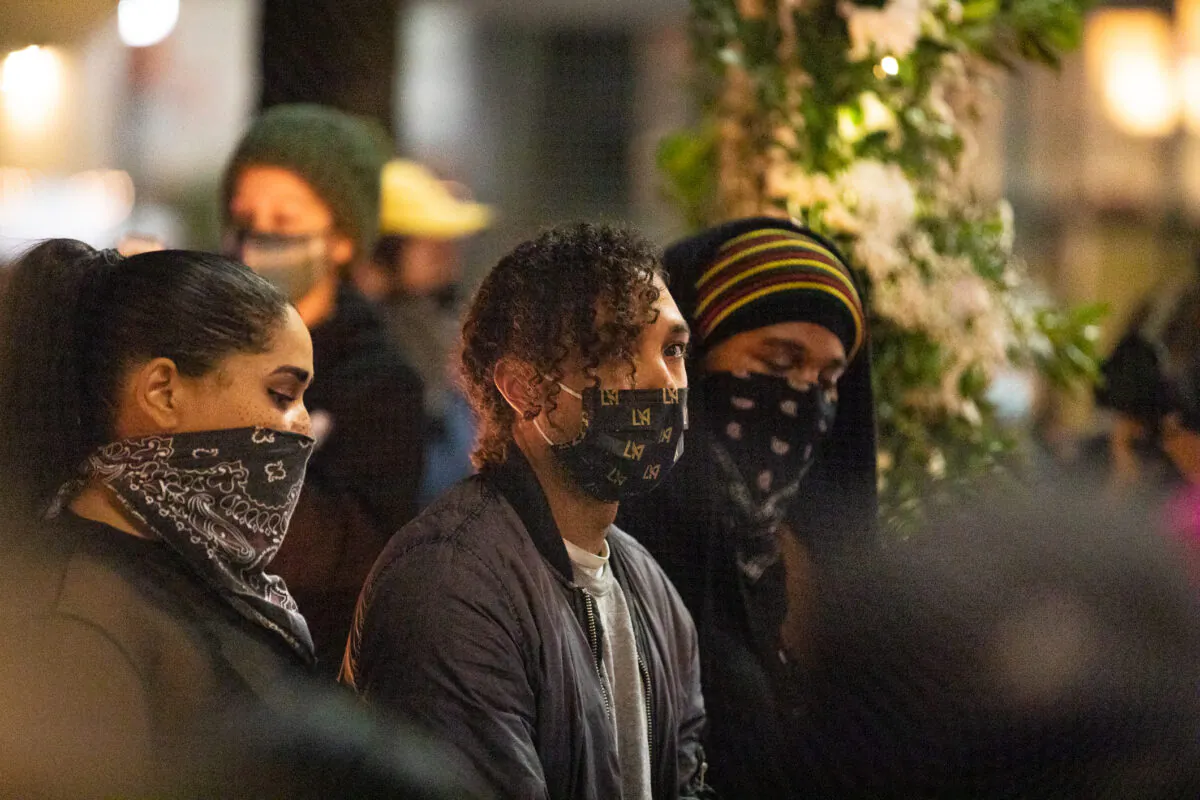 People gather to show solidarity for police shooting victim Daunte Wright in front of a Chase Bank building on the corner of Sunset Boulevard and Vine Street in Los Angeles, Calif., on April 16, 2021. (John Fredricks/The Epoch Times)