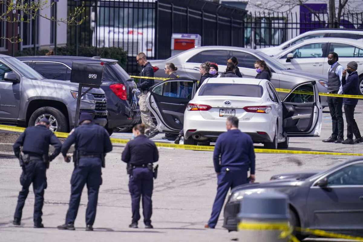 Law enforcement confer at the scene, in Indianapolis, where multiple people were shot at a FedEx Ground facility near the Indianapolis airport, on April 16, 2021. (Michael Conroy/AP Photo)