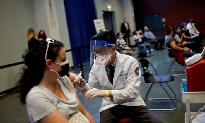 A woman receives a dose of the Johnson & Johnson COVID-19 vaccine at vaccination center in Chinatown, in Chicago U.S., April 6, 2021. (Reuters/Carlos Barria)