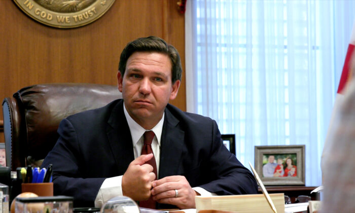 Floridа Gov. Ron DeSantis listens to a report from a member of his administration during a meeting at the governor's office in Tallahassee, Fla., on April 1, 2021. (Screenshot via Epoch Times)