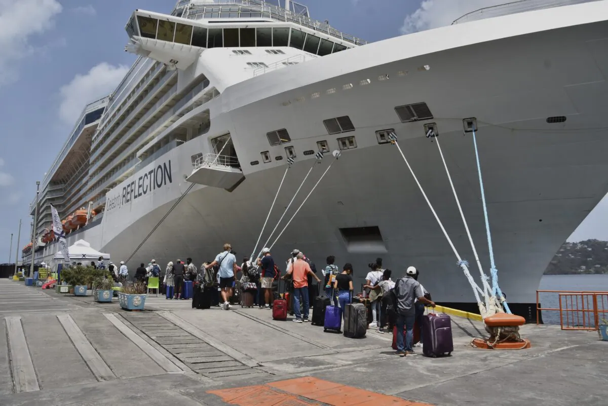 British, Canadian and U.S. nationals line up alongside the Royal Caribbean cruise ship Reflection to be evacuated free of charge, in Kingstown on the eastern Caribbean island of St. Vincent, on April 16, 2021. (Orvil Samuel/AP Photo)
