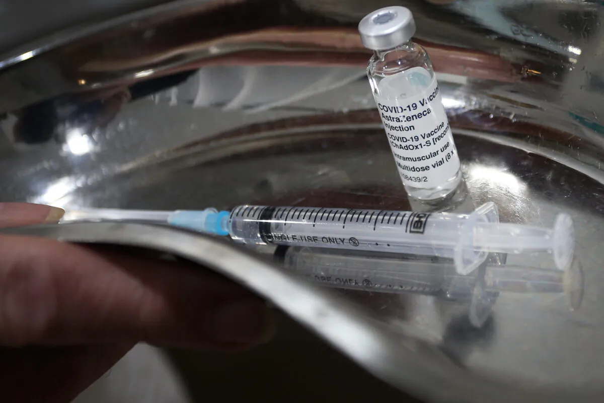 A nurse handles an AstraZeneca COVID-19 vaccine vial at a clinic in Sydney, Australia, on March 23, 2021. (Lisa Maree Williams/Getty Images)