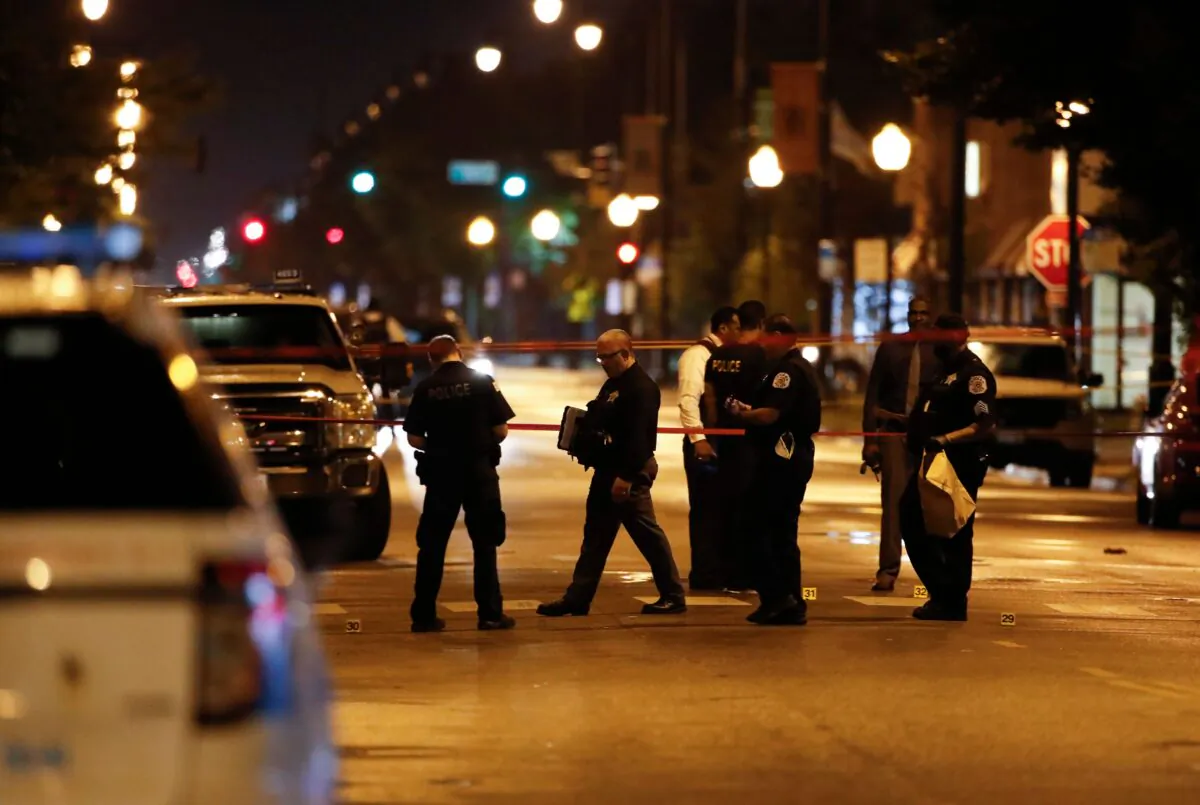 Police officers investigate the scene of a shooting in Chicago, Ill., in a file photo (Kamil Krzaczynski/AFP via Getty Images)