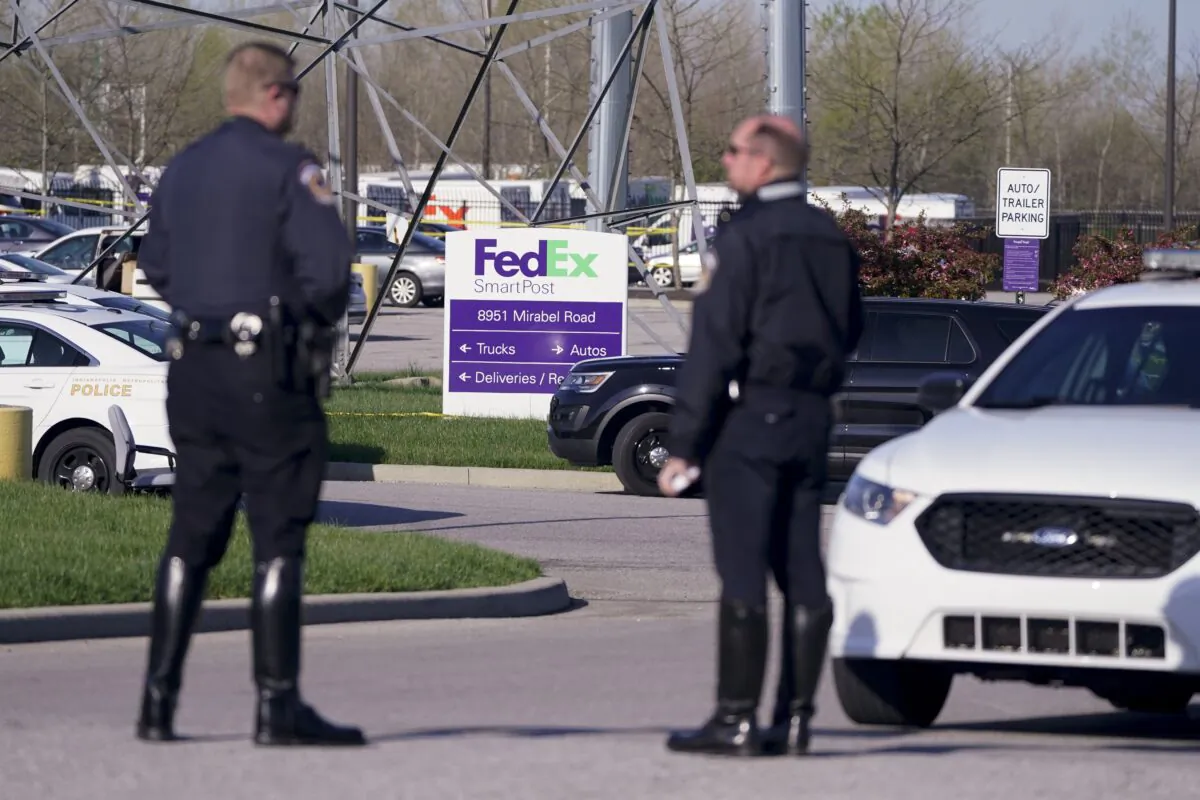 Police stand near the scene where multiple people were shot at the FedEx Ground facility in Indianapolis, Ind., on April 16, 2021. (Michael Conroy/AP Photo)