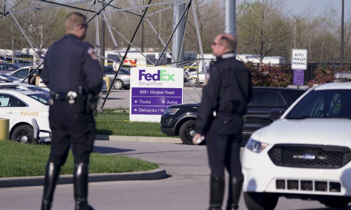 Police stand near the scene where multiple people were shot at the FedEx Ground facility in Indianapolis, Ind., on April 16, 2021. (Michael Conroy/AP Photo)
