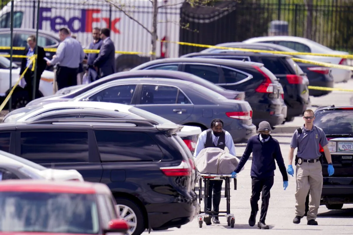 A body is taken from the scene where multiple people were shot at a FedEx Ground facility in Indianapolis, Ind., on April 16, 2021. (Michael Conroy/AP Photo)