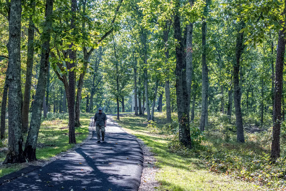 A man walks down Battlefield Trail at Kings Mountain National Military Park. (JNix/Shutterstock)
