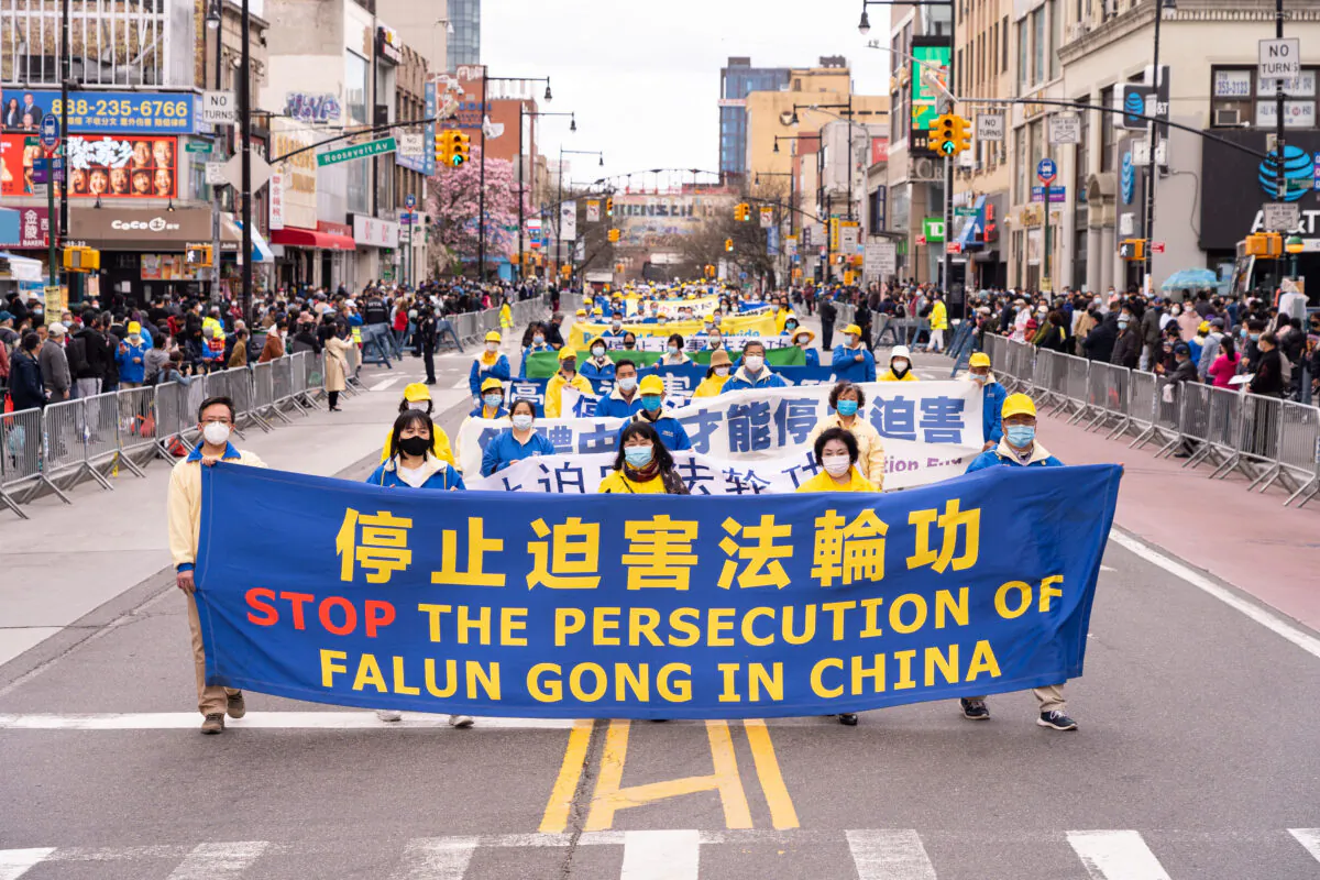 Falun Gong practitioners take part in a parade in Flushing, New York, on April 18, 2021, to commemorate the 22nd anniversary of the April 25th peaceful appeal of 10,000 Falun Gong practitioners in Beijing. (Larry Dye/The Epoch Times)