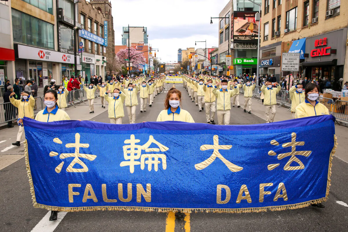 Falun Gong practitioners take part in a parade in Flushing, New York, on April 18, 2021, to commemorate the 22nd anniversary of the April 25th peaceful appeal of 10,000 Falun Gong practitioners in Beijing. (Samira Bouaou/The Epoch Times)