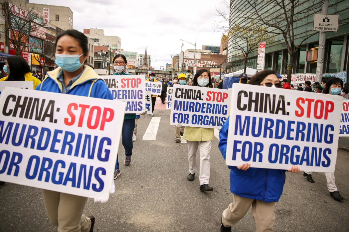 Falun Gong practitioners take part in a parade in Flushing, New York, on April 18, 2021, to commemorate the 22nd anniversary of the April 25th peaceful appeal of 10,000 Falun Gong practitioners in Beijing. (Samira Bouaou/The Epoch Times)