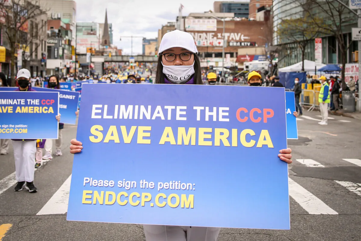 Falun Gong practitioners take part in a parade to commemorate the 22nd anniversary of the April 25th peaceful appeal of 10,000 Falun Gong practitioners in Beijing, in Flushing, N.Y., on April 18, 2021. (Samira Bouaou/The Epoch Times)