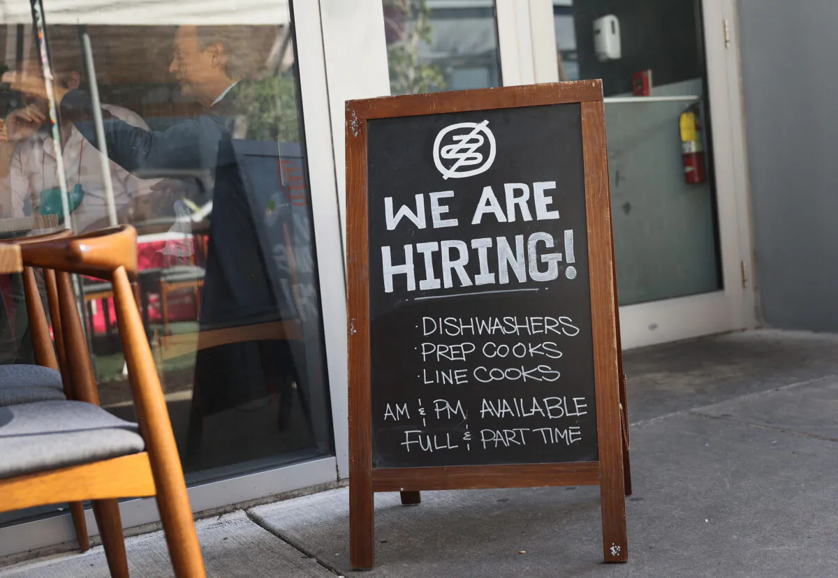 A "We are hiring!" sign is seen in front of the Buya restaurant in Miami, Fla., on March 5, 2021. (Joe Raedle/Getty Images)