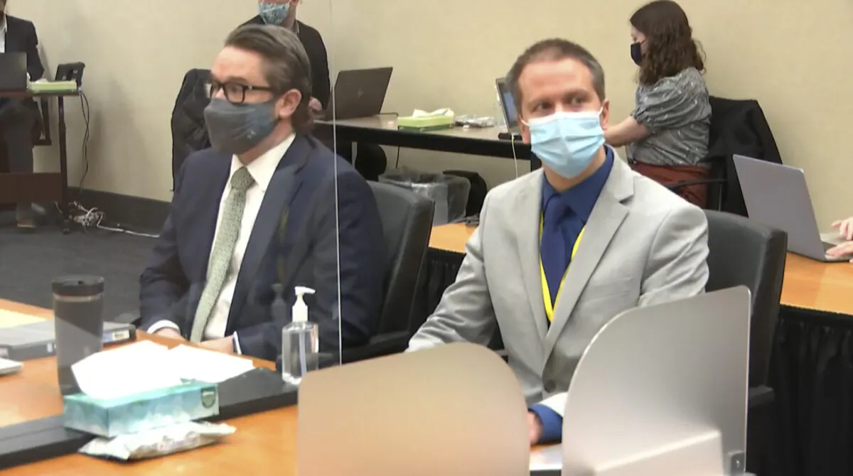 In this image from video, defense attorney Eric Nelson (L) and defendant, former Minneapolis police officer Derek Chauvin, listen to Hennepin County Judge Peter Cahill read instructions to the jury before closing arguments, in the trial of Chauvin at the Hennepin County Courthouse in Minneapolis, Minn., on April 19, 2021. (Court TV via AP)