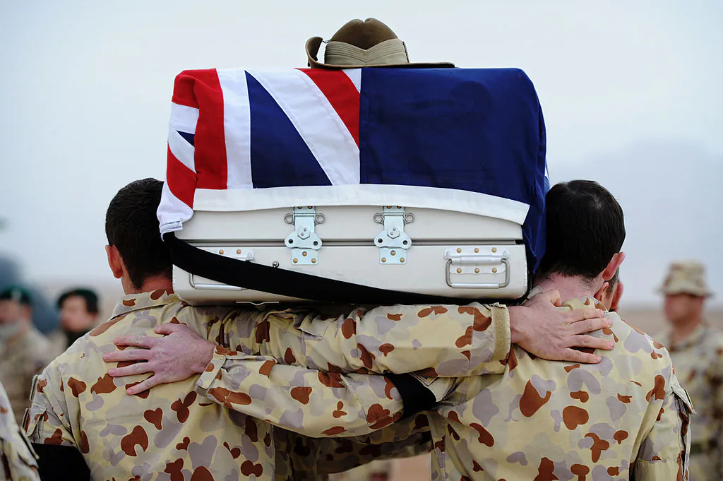 In this handout photo provided by ISAF Regional Command (South), Australian defense engineers carry the casket of their friend and colleague Cpl. Richard Atkinson at Multinational Base Tarin Kot in Uruzgan, Afghanistan on February 5, 2011. (Australian Cpl. Christopher Dickson/Australian Department of Defense via Getty Images)