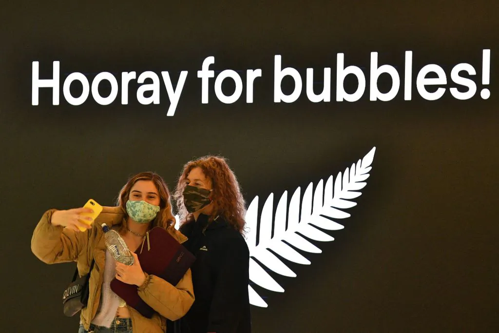Travellers take selfies before their departure for New Zealand at Sydney International Airport on April 19, 2021. (Saeed Khan/Getty Images)
