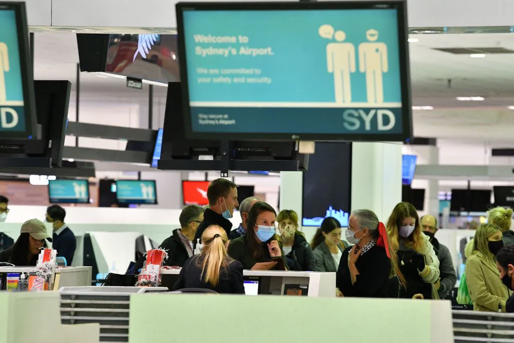 Passengers check in at the counter for New Zealand flights at Sydney International Airport on April 19, 2021, as Australia and New Zealand opened a trans-Tasman quarantine-free travel bubble. (Saeed Khan/Getty Images)