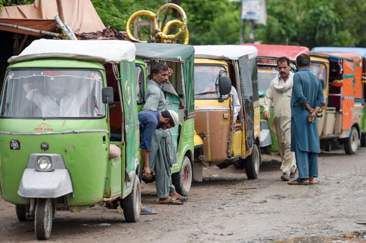 Auto-rickshaw drivers wait for customers on the outskirts of Islamabad, Pakistan, on August 26, 2019. (FAROOQ NAEEM/AFP via Getty Images)