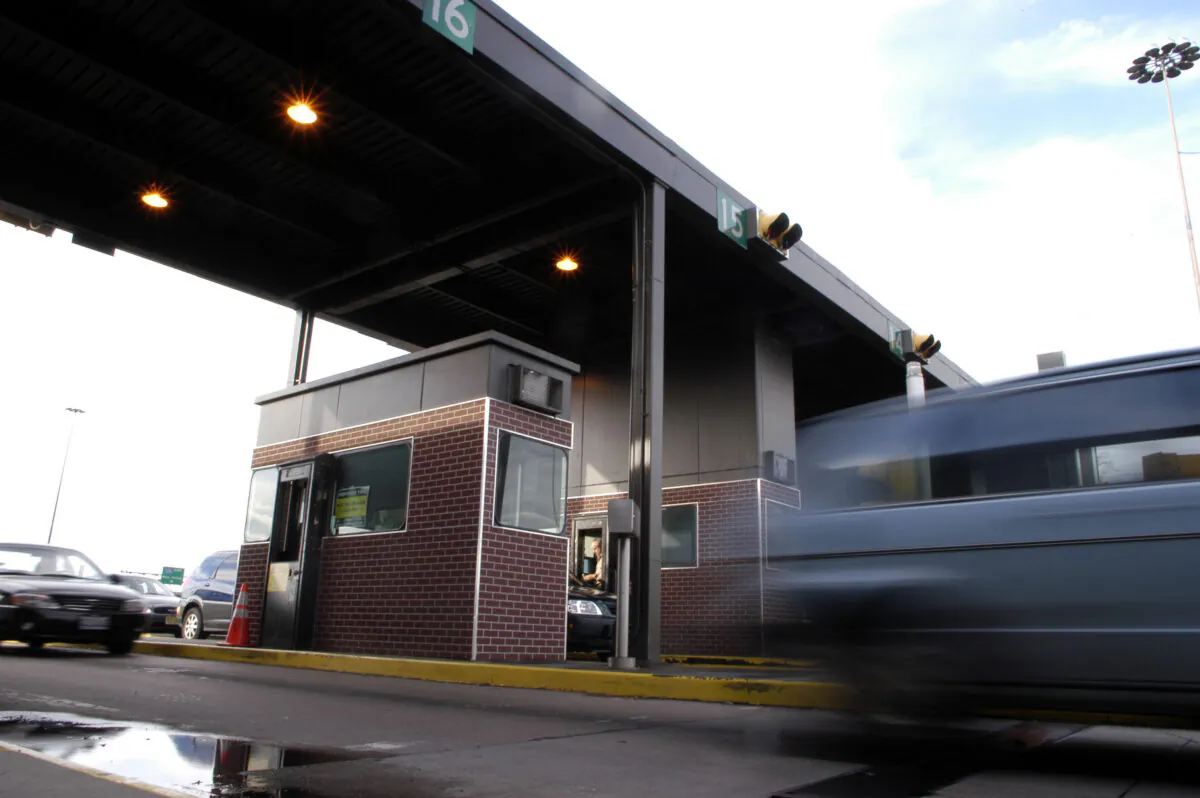 A vehicle passes through a tollbooth somewhere... (William Thomas Cain/Getty Images)