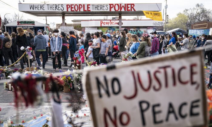 Demonstrators gather for a rally in memory of George Floyd and Daunte Wright outside Cup Foods in Minneapolis, Minn., on April 18, 2021. (John Minchillo/AP Photo)